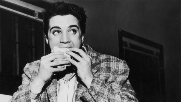 Elvis eating a cheeseburger