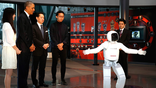 Barack Obama plays football with a robot