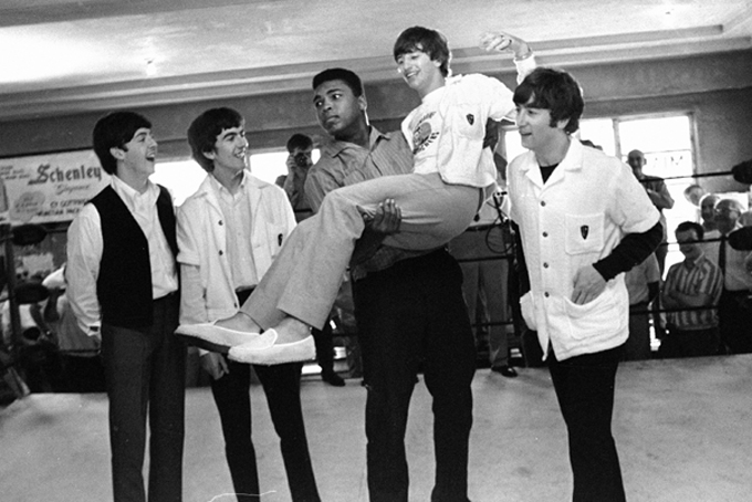 FILE - In this Feb. 18, 1964 file photo, boxer Cassius Clay lifts Beatles member Ringo Starr while the singers visited Clay's camp in Miami Beach, Fla. Others from left are Paul McCartney, George Harrison and John Lennon. A few days earlier the British musicians had appeared for the first time on the Ed Sullivan Show. A week later, Clay would beat Sonny Liston and go on to even greater things as Muhammad Ali. (AP Photo)