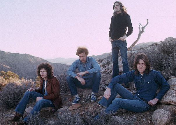 March 1972 --- The rock band The Eagles rest in a desert valley.  The Eagles were the most popular band of the seventies and their reunion tour in the nineties was also very successful. --- Image by © Henry Diltz/CORBIS