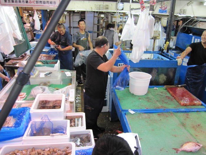 tokyo fish market overhead of fish workers